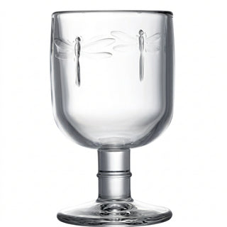 A clear glass wine glass with a solid base and embossed dragonfly design.
